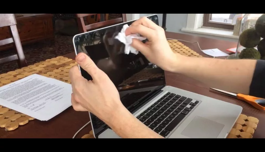 Cleaning MacBook with cloth