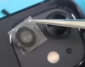 Using tweezers to replace lens